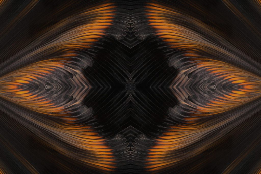 a black and orange abstract background with an intricate design